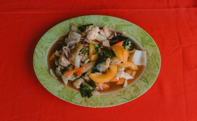 Braised vegetables in sauce in colorful Asian restaurant