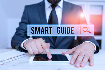 Obraz premium Conceptual hand writing showing Smart Guide. Concept meaning used to guide the development of measurable goals to attain Male human wear formal clothes present use hitech smartphone