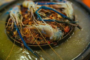 Shrimp and vegetables cooking process on Hot Pot pan Grill in restaurant
