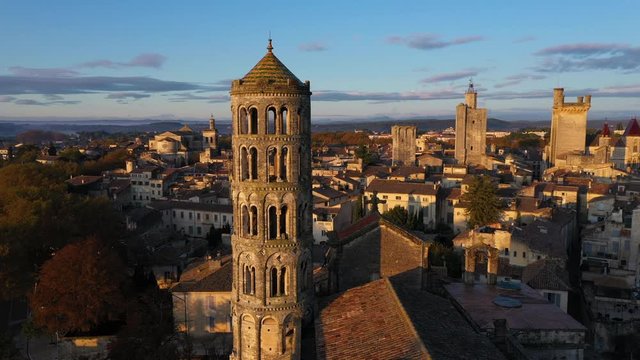Saint-Th&eacute;odorit cathedral and its Fenestrelle Tower aerial flight during sunrise Uzes France Gard