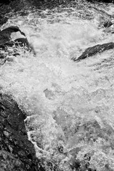 Close up view of the rushing waters of a waterfall.