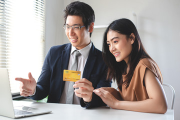 Couples or office workers use credit cards to shop online with pleasant expressions.