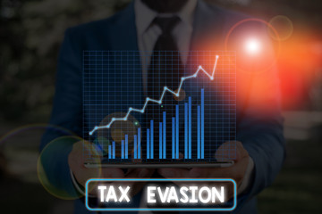 Conceptual hand writing showing Tax Evasion. Concept meaning the failure to pay or the deliberate underpayment of taxes