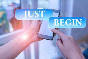 Text sign showing Just Begin. Business photo text to start to happen Begin to do something in business or a job woman using smartphone office supplies technological devices inside home