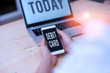 Text sign showing Debit Card. Business photo showcasing card that deducts money directly from a demonstrating s is checking account woman laptop computer smartphone mug office supplies technological