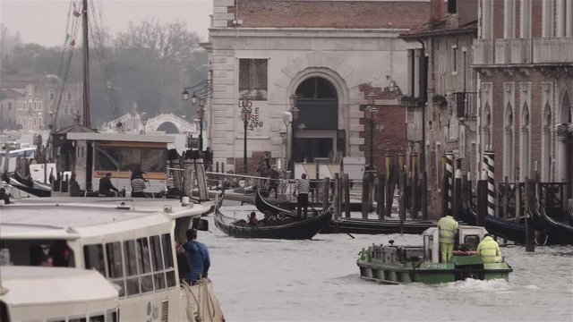 Water transportation on one of the canals of Venice, traffic of ferries, boats, gondolas. Slow motion