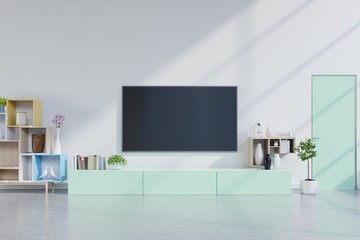 TV on green cabinet in modern living room with plants in living room with empty white wall.