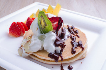 pankaques with ice cream, fruit and chocolate sauce