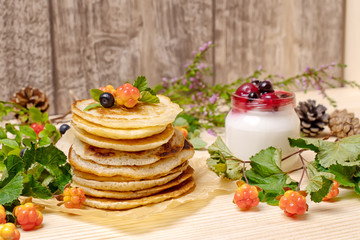 Pancakes with black currant berries and yogurt