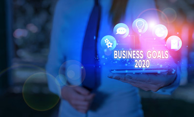 Writing note showing Business Goals 2020. Business concept for Advanced Capabilities Timely...