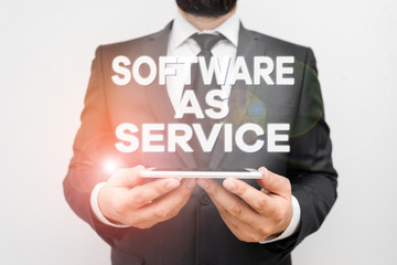 Text sign showing Software As Service. Business photo text On Deanalysisd licensed on Subscription and centrally hosted Male human wear formal work suit hold smart hi tech smartphone use hands