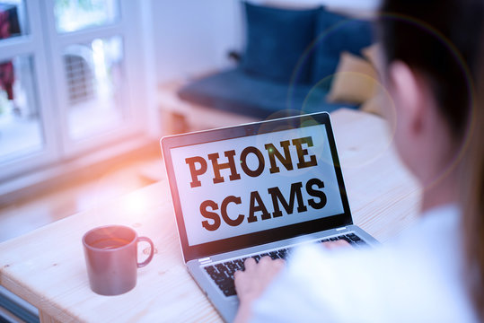 Writing note showing Phone Scams. Business concept for use of telecommunications for illegally acquiring money woman laptop computer office supplies technological devices inside home