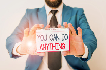 Word writing text You Can Do Anything. Business photo showcasing Motivation for doing something Believe in yourself Man holds empty paper with copy space in front of him Copy Space