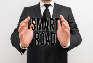 Writing note showing Smart Road. Business concept for number of different ways technologies are incorporated into roads Male human with beard wear formal working suit clothes hand