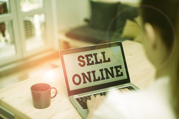 Writing note showing Sell Online. Business concept for directly sell goods or services to a buyer over the Internet woman laptop computer office supplies technological devices inside home