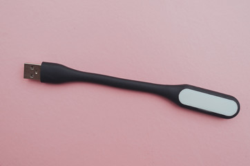 flexible usb flashlight in black on a pink background