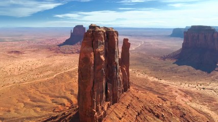 Drone flight towards the Mitten Butte, one of the sandstone rock formations of Monument Valley. Utah and Arizona border, USA Aerial 4K. Monument Valley Navajo Tribal Park