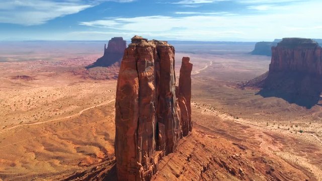 Drone flight towards the Mitten Butte, one of the sandstone rock formations of Monument Valley. Utah and Arizona border, USA Aerial 4K. Monument Valley Navajo Tribal Park