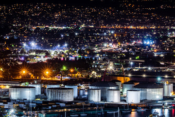 Brightly colored, Illuminated oil refinery and oil tanks at night