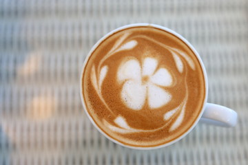 frangipani plumeria fragrant flower of latte art in hot coffee drink put on table in cafe restaurant