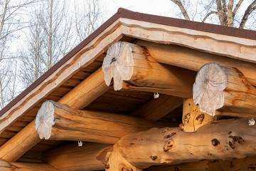 Wooden roof mounted on huge trunks of solid pine, wooden columns