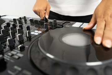 Hands of DJ mixing tracks on professional Dj Mixer