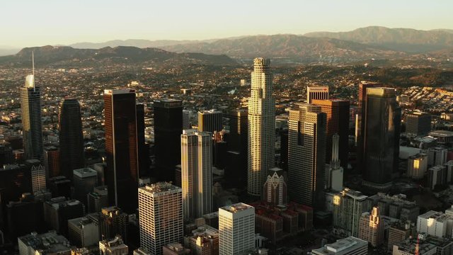 Aerial of downtown Los Angeles in dawn, sunset in California, skyscrapers and office buildings, golden light