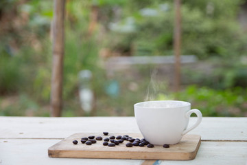 Coffee cup and coffee beans on table