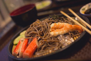 Soba with sea food, cold noodle from Japan serve with crab and shimp meat eating with miso soup
