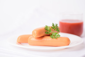 Delicious fresh sausages on a white background prepared for a holiday party