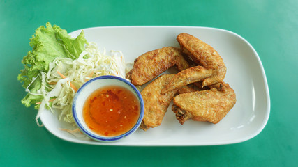 Fried salted chicken wings with fresh vegetable with dipping sauce