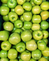 Fototapeta na wymiar green apples in a box in the foreground