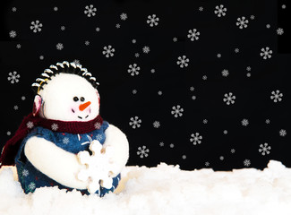 Happy Snowman in snow on black background. Holiday theme