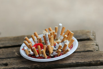 cigarette butts in a plastic plate