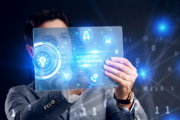 Planning marketing strategy. Business, Technology, Internet and network concept. Businessman working on the tablet of the future, select on the virtual display: Marketing automation