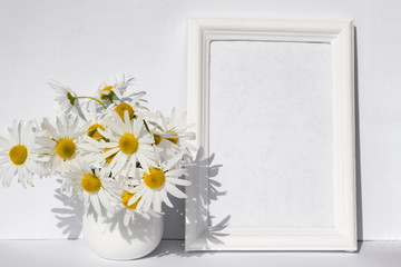 Bouquet of white field daisies in a vase on a background of light paper with a copy of space, space for text. Summer, spring mock up 