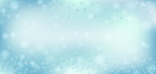 Blue bokeh background. Christmas glowing lights with sparkles and snowflakes. Holiday decorative effect.