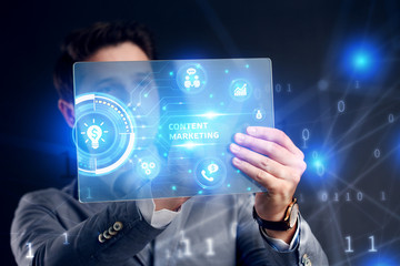 Planning marketing strategy. Business, Technology, Internet and network concept. Businessman working on the tablet of the future, select on the virtual display: Content marketing