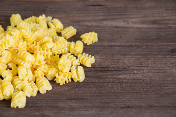 Durum wheat pasta on a dark wooden table. Copy spase