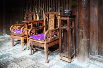 A Naxi style wooden chairs at the living room. These oriental furniture is an antique from the Naxi village.    