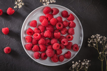 Fresh Raspberries in bowl on wooden table