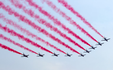 Jet plane flying in blue sky wiht Colorful smoke.Aerospace exhibition at airshow in Zhuhai, Guangdong Province of China.