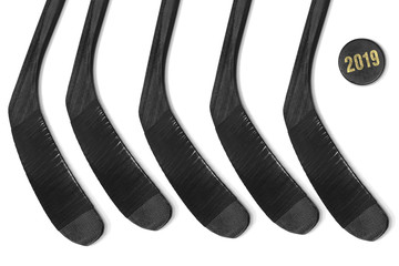 Five hockey sticks and puck on ice