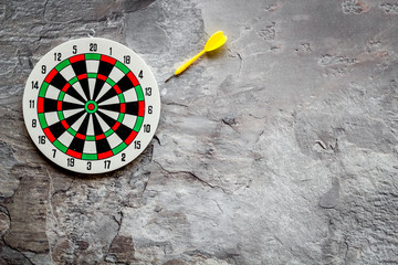 Darts game - simple sport for lesure time. Dartboard and arrows or dart on grey background top view...