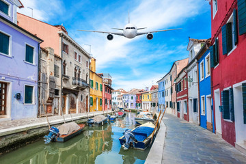 Fototapeta na wymiar Front of real plane aircraft, on Burano Colorful house in Venice, Italy background