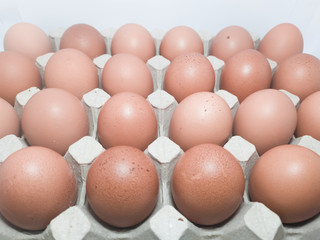 Brown eggs in carton box.