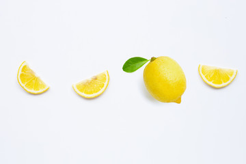 Fresh lemon with green leaf on white