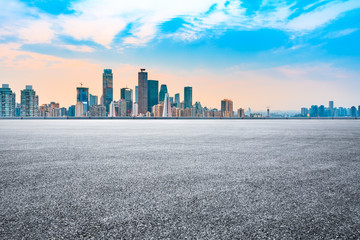Fototapeta premium Sunset empty asphalt road and city skyline in Chongqing