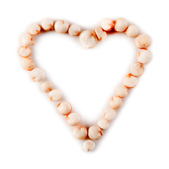 Heart made of quinoa seeds isolated on a white background. Macro photography.