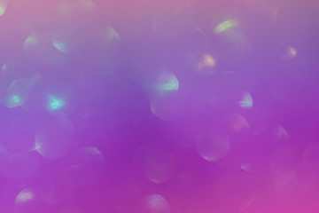 Abstract colorful bright sparkling background, defocused christmas lights. Blurred background for holidays and parties in trendy colors.